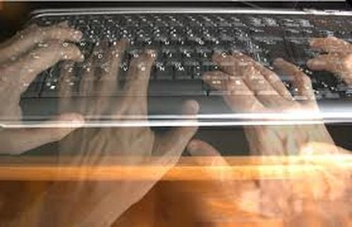Image of hands typing on typewriter